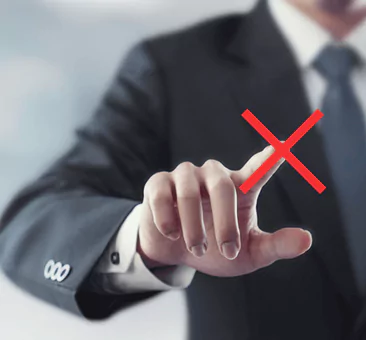 A man pointing to a red x mark on the screen.